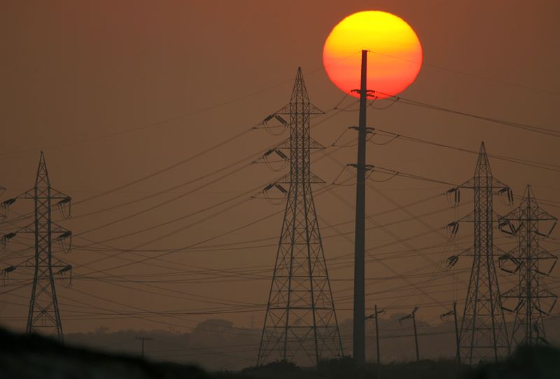 Sun sets behind power lines in California