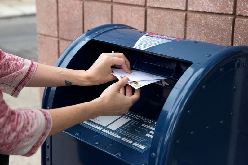 FILE PHOTO: An individual mails letters through the U.S. Postal