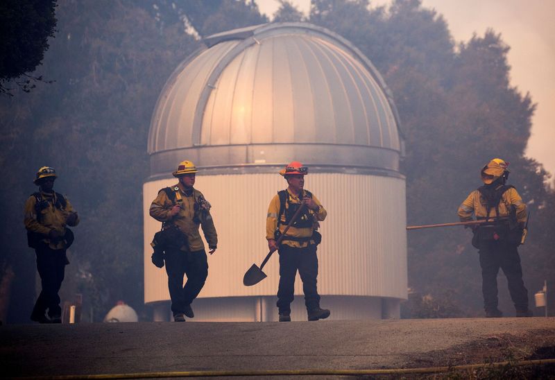 FILE PHOTO: Firefighters walk while defending the Mount Wilson Observatory