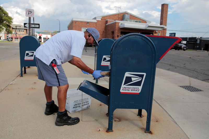 A United States Postal Service (USPS) worker handles the mail