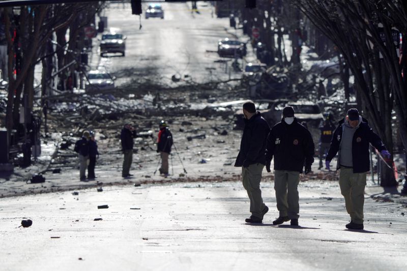 FILE PHOTO: Investigators work near the site of an explosion