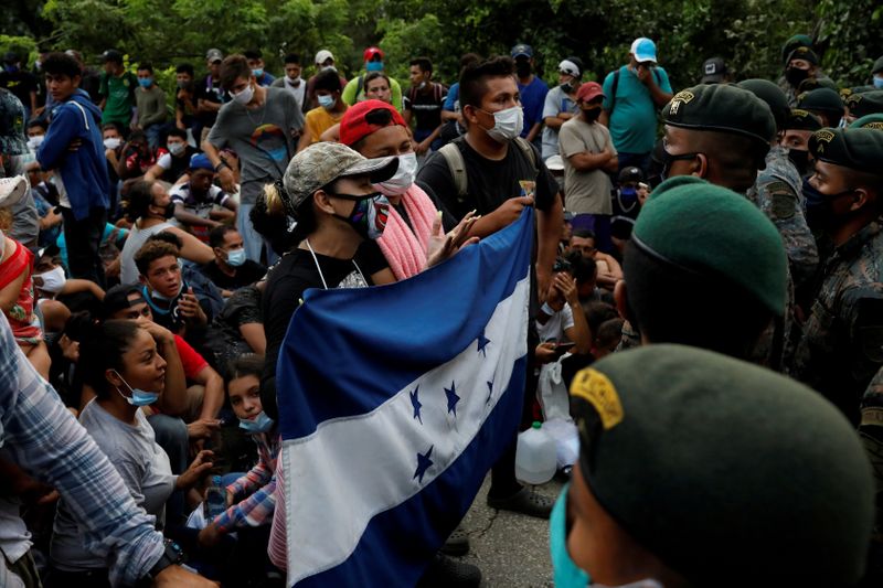 FILE PHOTO: Honduran migrants trying to reach the U.S. hold