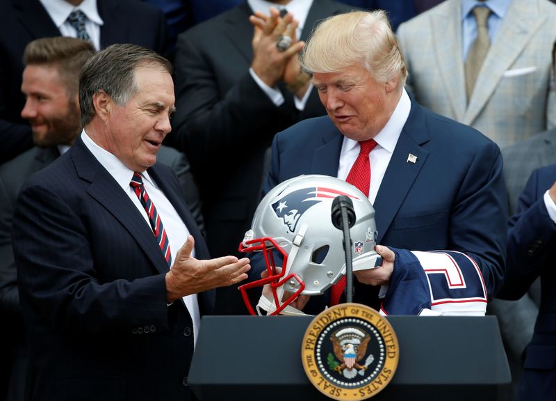 U.S. President Donald Trump holds a New England Patriots helmet