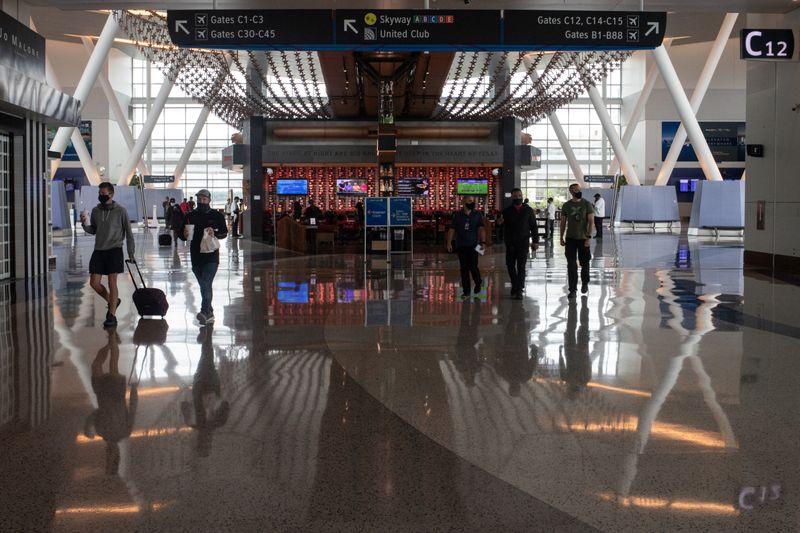 FILE PHOTO: Travelers walk through Terminal C of IAH George