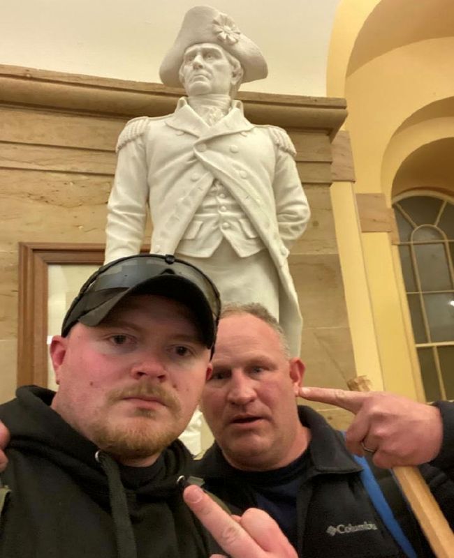 Fracker and Robertson, off-duty Rocky Mount, Virginia police officers, gesture