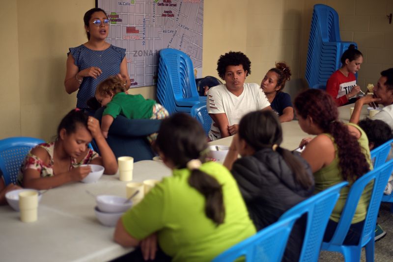Honduran migrants, sent back to Guatemala from the U.S., sit