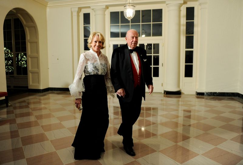 FILE PHOTO: Shultz arrives with his wife arrive for a