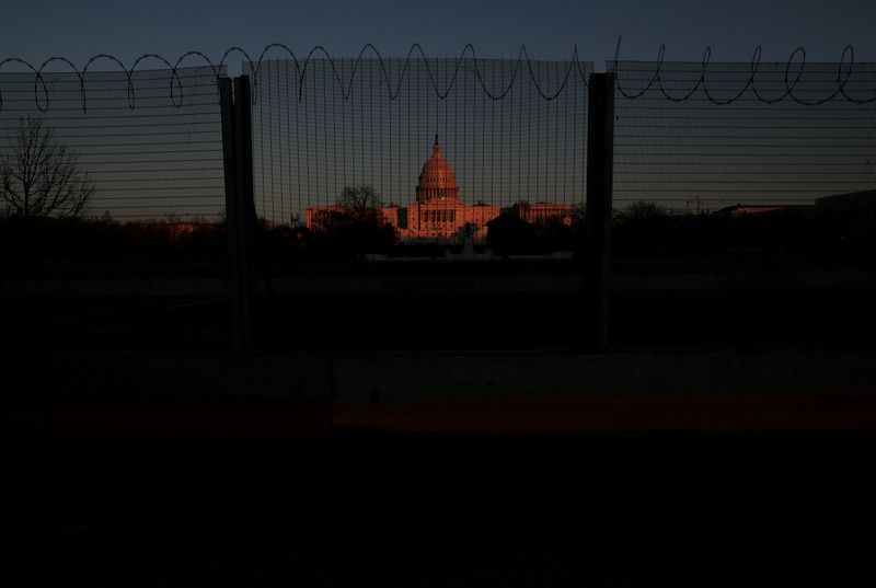 FILE PHOTO: The U.S. Capitol Building is seen behind barbed