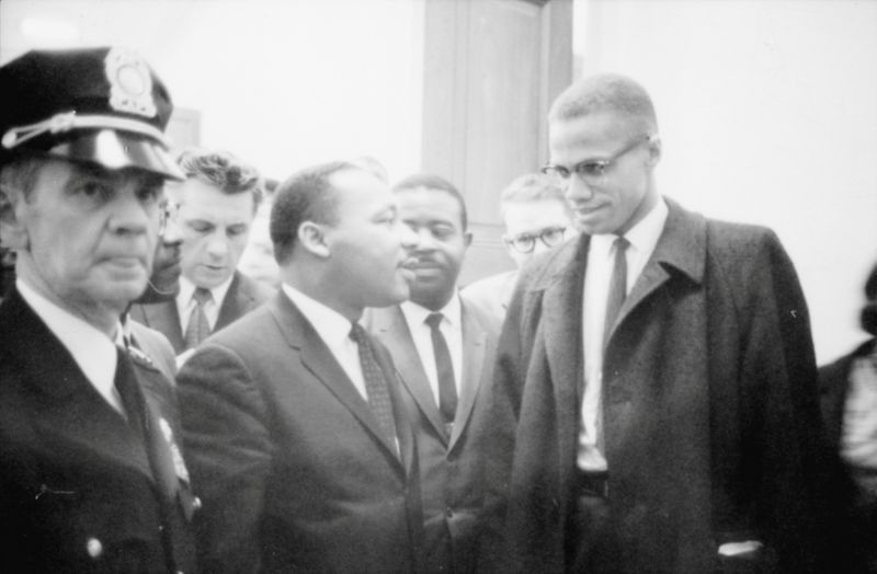 FILE PHOTO: Martin Luther King Jr. and Malcolm X wait