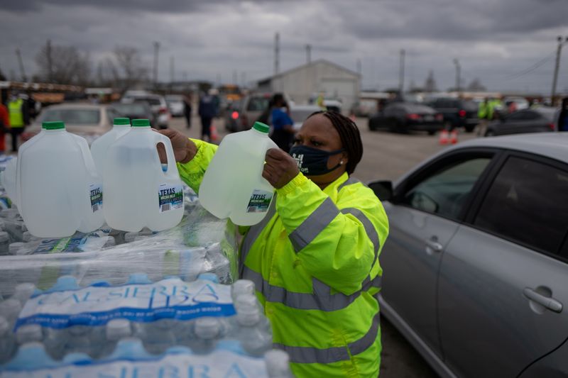 Volunteers give water to residents affected by unprecedented winter storm