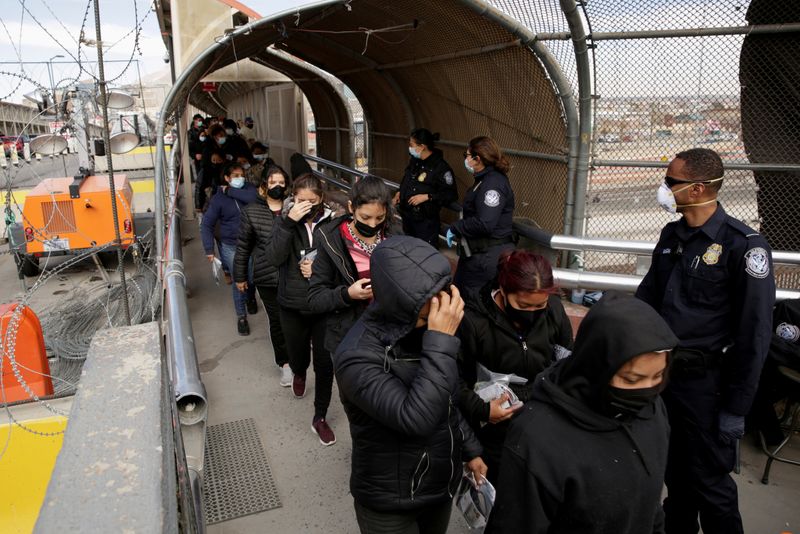 FILE PHOTO: Migrants deported from the U.S. walk towards Mexico