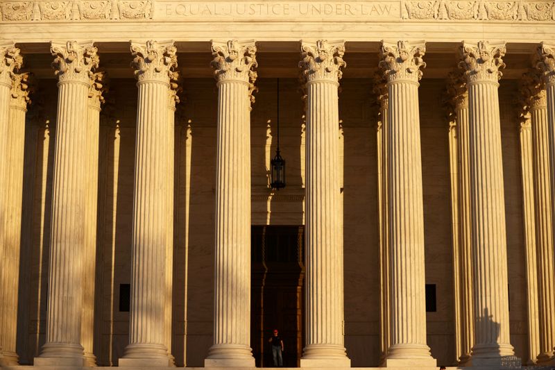 FILE PHOTO: A man walks at the U.S. Supreme Court