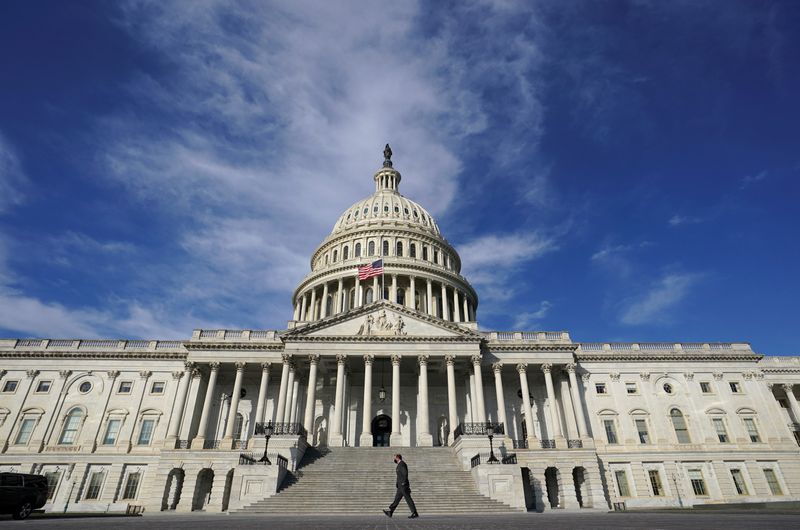 FILE PHOTO: A man walks past the U.S. Capitol in