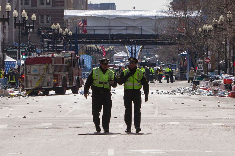 Boston police officers patrol down Boylston Street near the scene