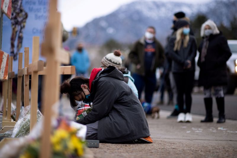FILE PHOTO: People leave flowers at the site of a