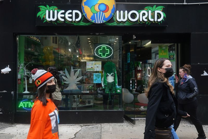 People walk past a Weed World store the day New