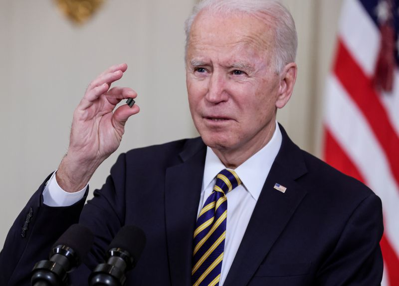 FILE PHOTO: U.S. President Joe Biden holds a chip as