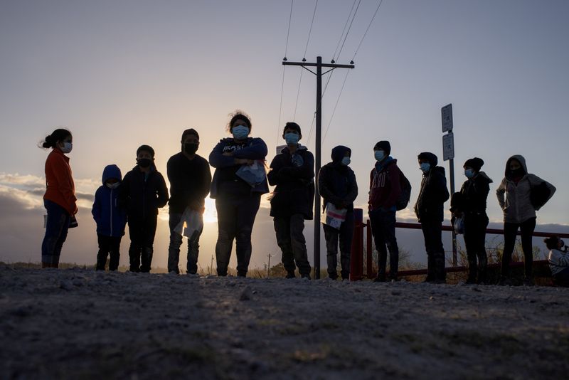 FILE PHOTO: Migrants from Central America await transport after crossing