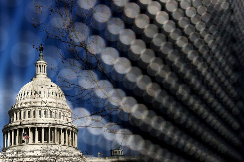 FILE PHOTO: Light catches the security fence around the U.S.