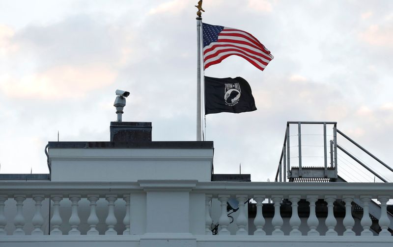 FILE PHOTO: The black POW-MIA flag flies underneath the American