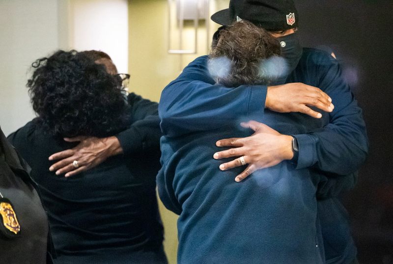 People embrace after learning that their loved one was safe