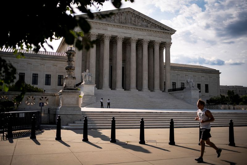 FILE PHOTO: A man runs past the U.S. Supreme Court