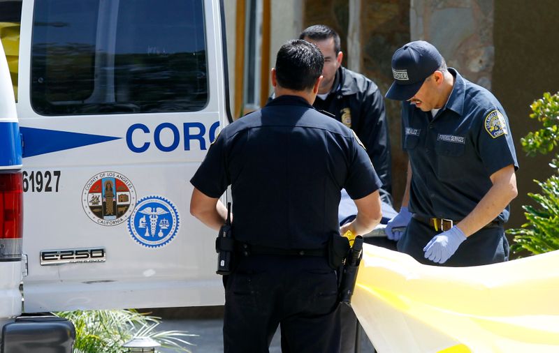 FILE PHOTO:Los Angeles County coroner and forensic specialists remove a