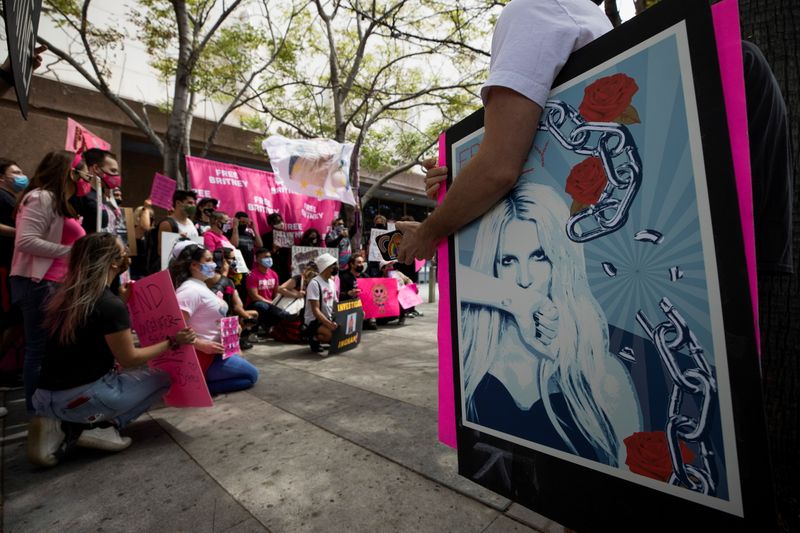 A supporter holds a poster during a rally for pop