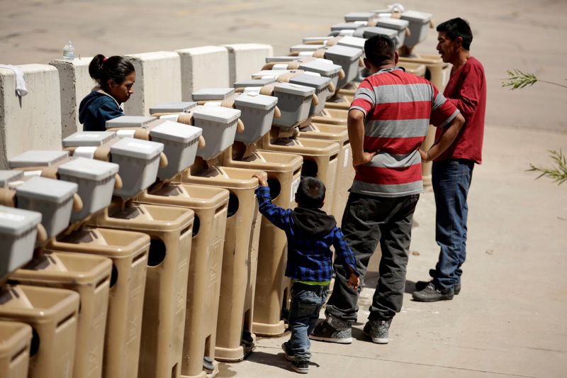FILE PHOTO: Migrants from Central America use the sinks at