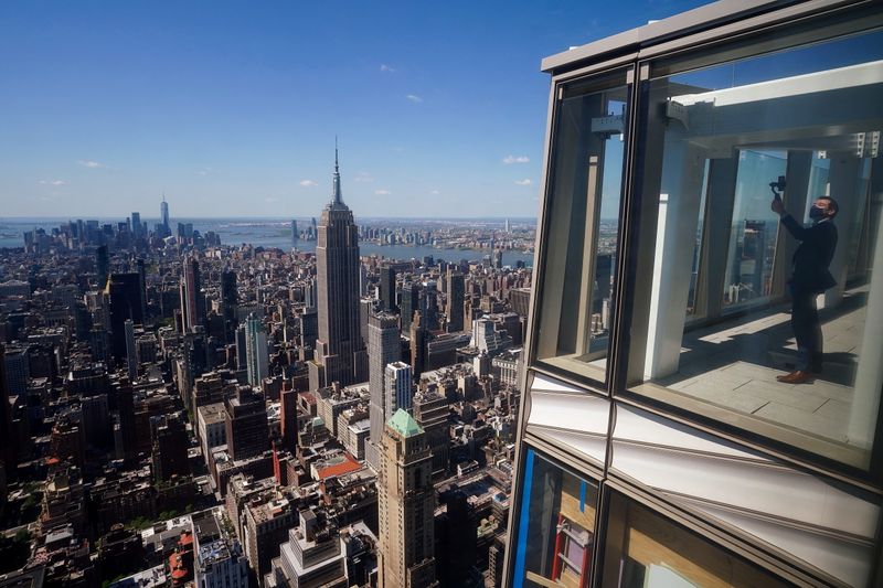 A man records a video from the observation deck of