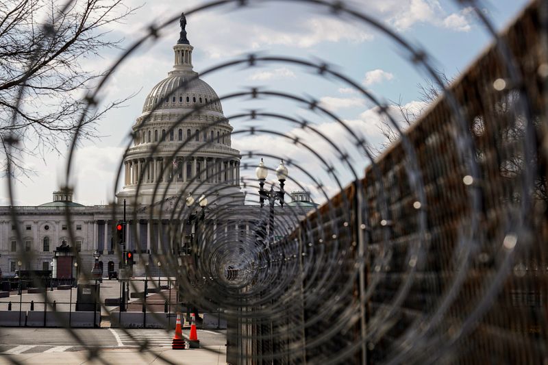 FILE PHOTO: The U.S. Capitol is seen through razor wire