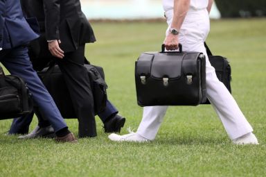 FILE PHOTO: A military aide carries the so-called nuclear football