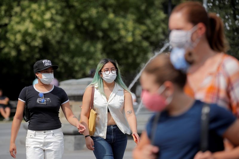 FILE PHOTO: People wear masks, as cases of the infectious