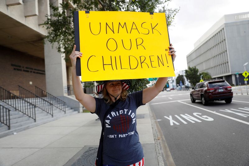 FILE PHOTO: People protest against the school mask mandate in