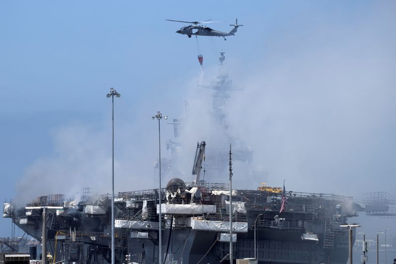 FILE PHOTO: U.S. Navy helicopters continue fighting a fire on