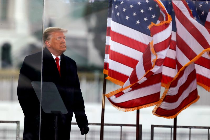 FILE PHOTO: FILE PHOTO: U.S. President Donald Trump holds a