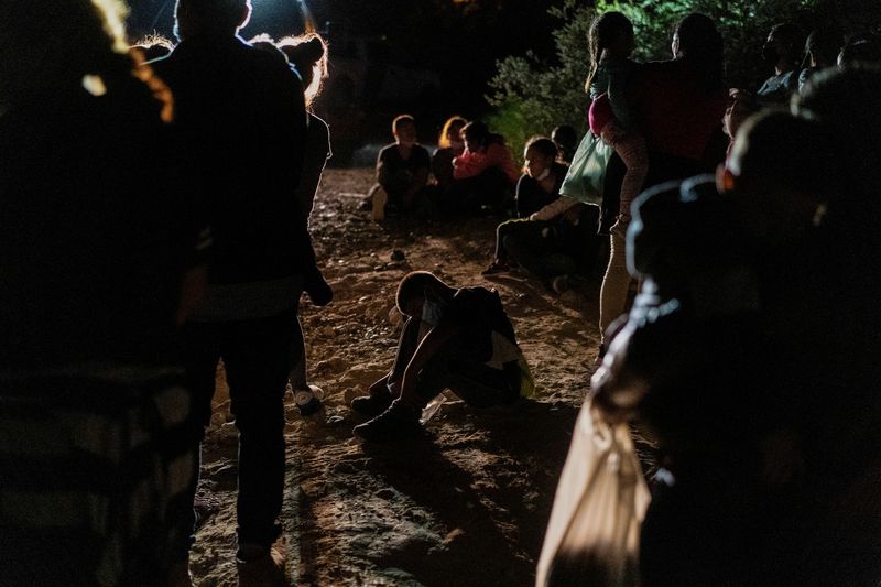 FILE PHOTO: Asylum-seeking migrants cross the Rio Grande river in