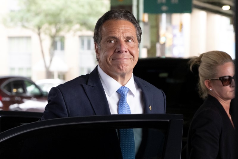 New York Governor Andrew Cuomo arrives to depart in his