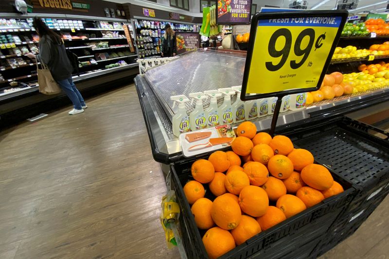 Oranges are displayed for sale at the produce area as