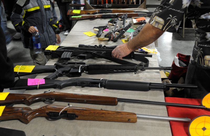 FILE PHOTO: Dealer displays firearms for sale at a gun
