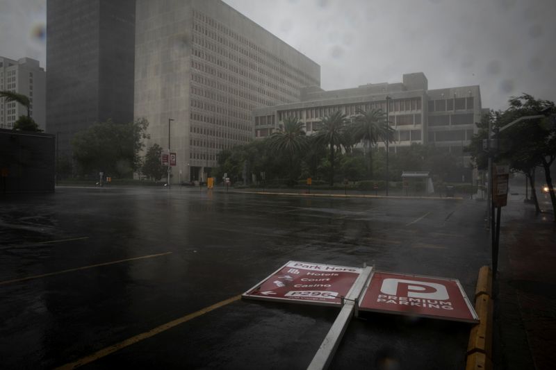 A parking sign lies in the street as Hurricane Ida