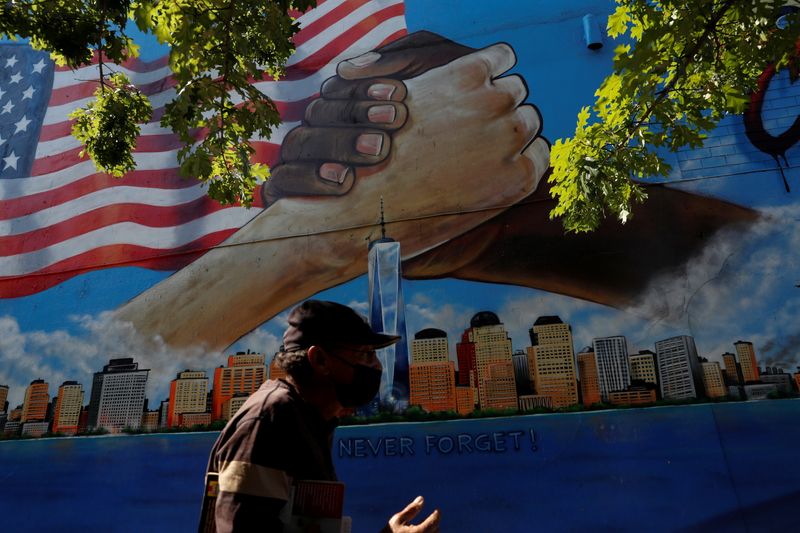 FILE PHOTO: A man walks by a 9/11 memorial mural