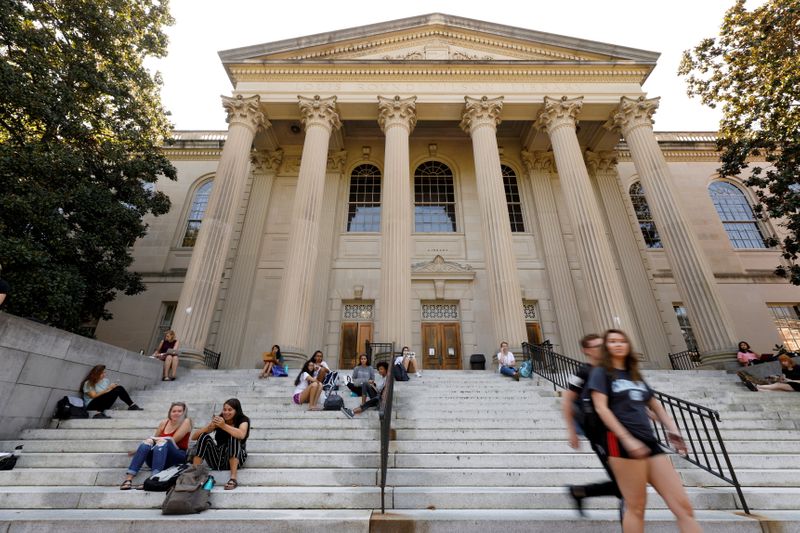 FILE PHOTO: Students sit on the steps of Wilson Library