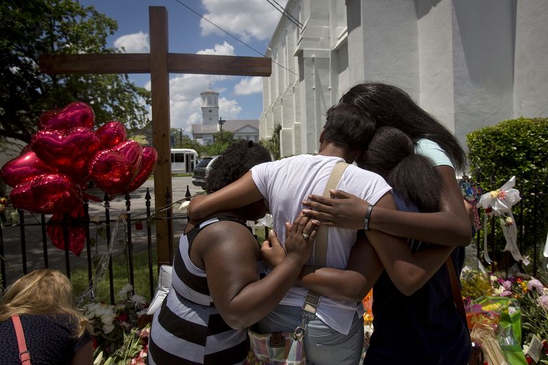 FILE PHOTO: Family members of a victim hug as they