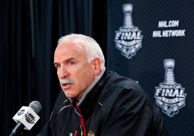 Blackhawks head coach Joel Quenneville answers a question from a