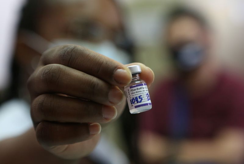 A nurse shows a dose of the Pfizer-BioNTech coronavirus disease