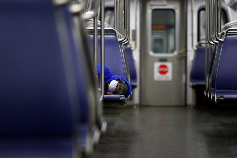 A person rests on a Washington Metro subway car wearing