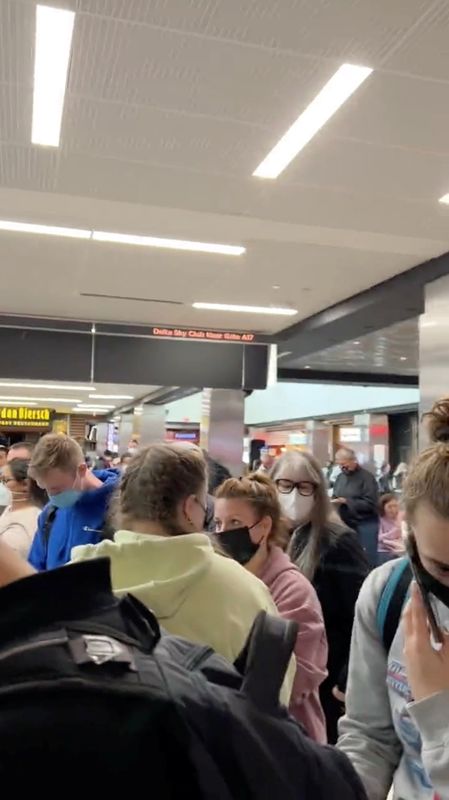 People gather to leave Hartsfield-Jackson Atlanta International Airport after reported