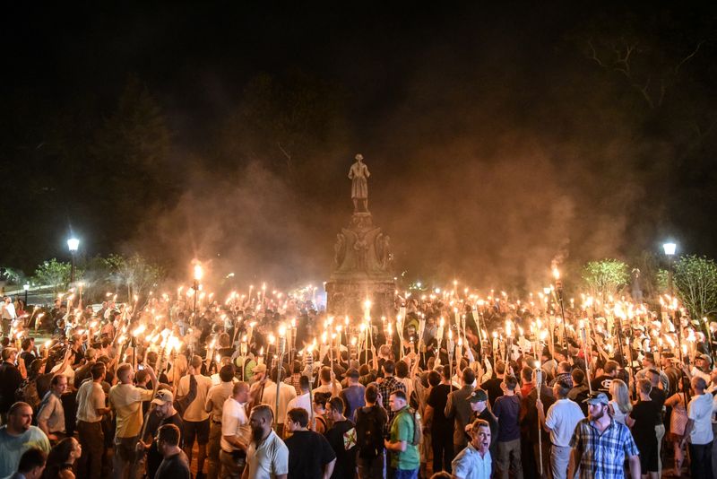 White nationalists participate in a torch-lit march on the grounds