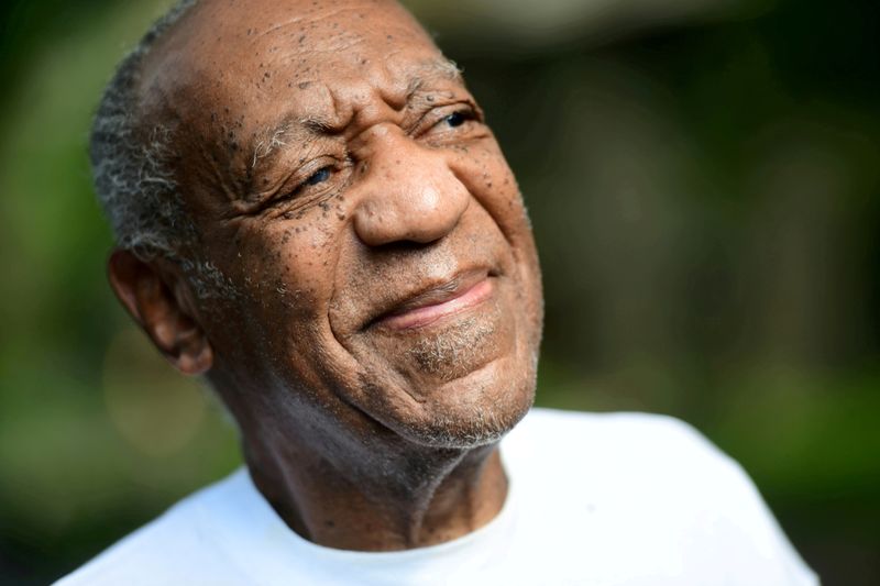 FILE PHOTO: Bill Cosby looks on outside his house after